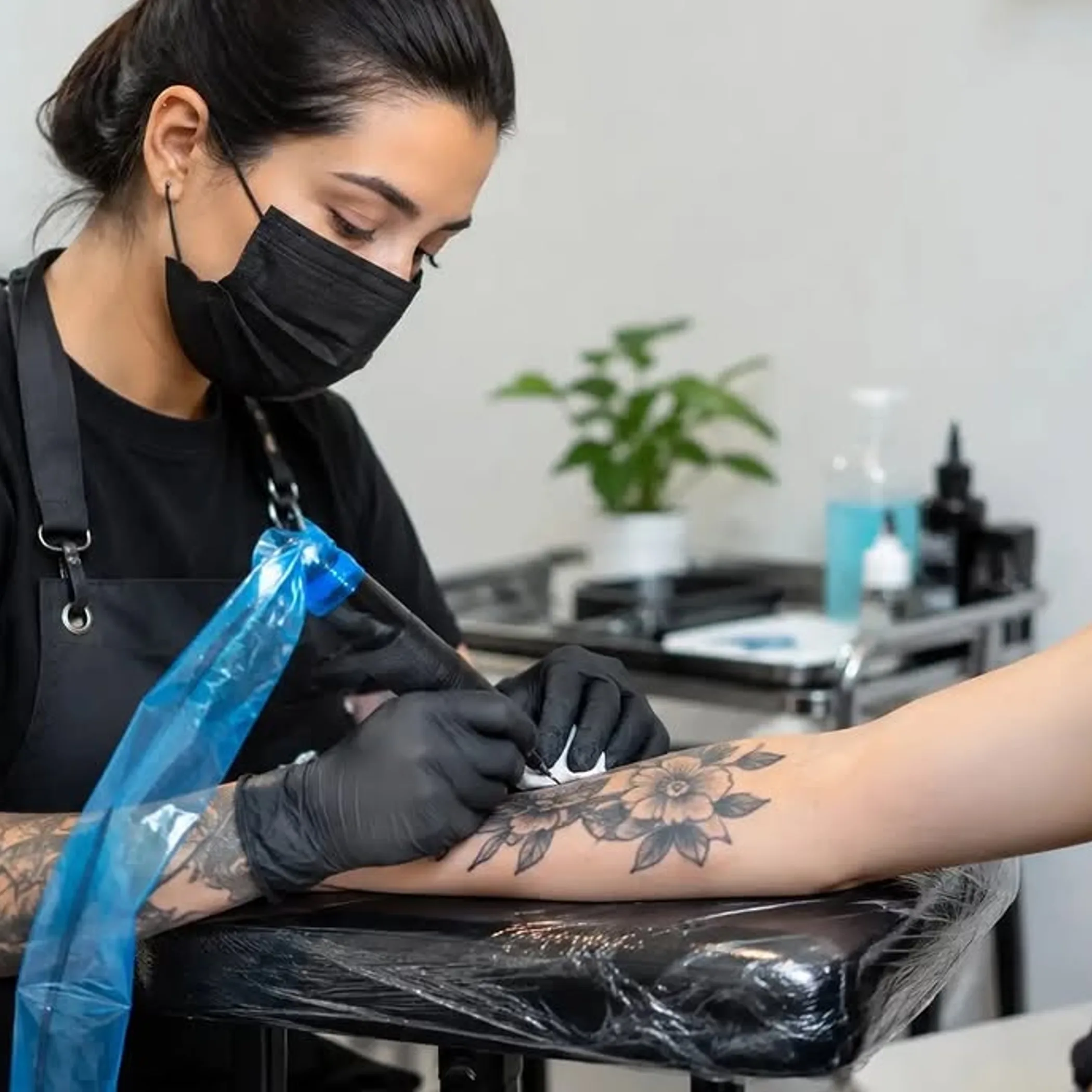 professional tattoo application with gloves and clean equipment
